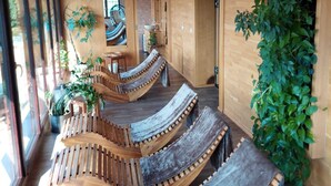 A modern interior with wooden furniture and large windows. - Horsky Hotel Hájenka (Makov)