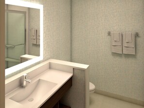 Une salle de bain avec un grand miroir, un lavabo et des toilettes.
