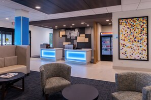 A hotel lobby with seating areas, a reception desk, and a minibar. - Holiday Inn Express & Suites Fort Worth West by IHG (Fort Worth)