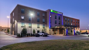 A Holiday Inn Express & Suites hotel with a modern design, featuring a prominent entrance and a parking lot. - Holiday Inn Express & Suites Fort Worth West by IHG (Fort Worth)