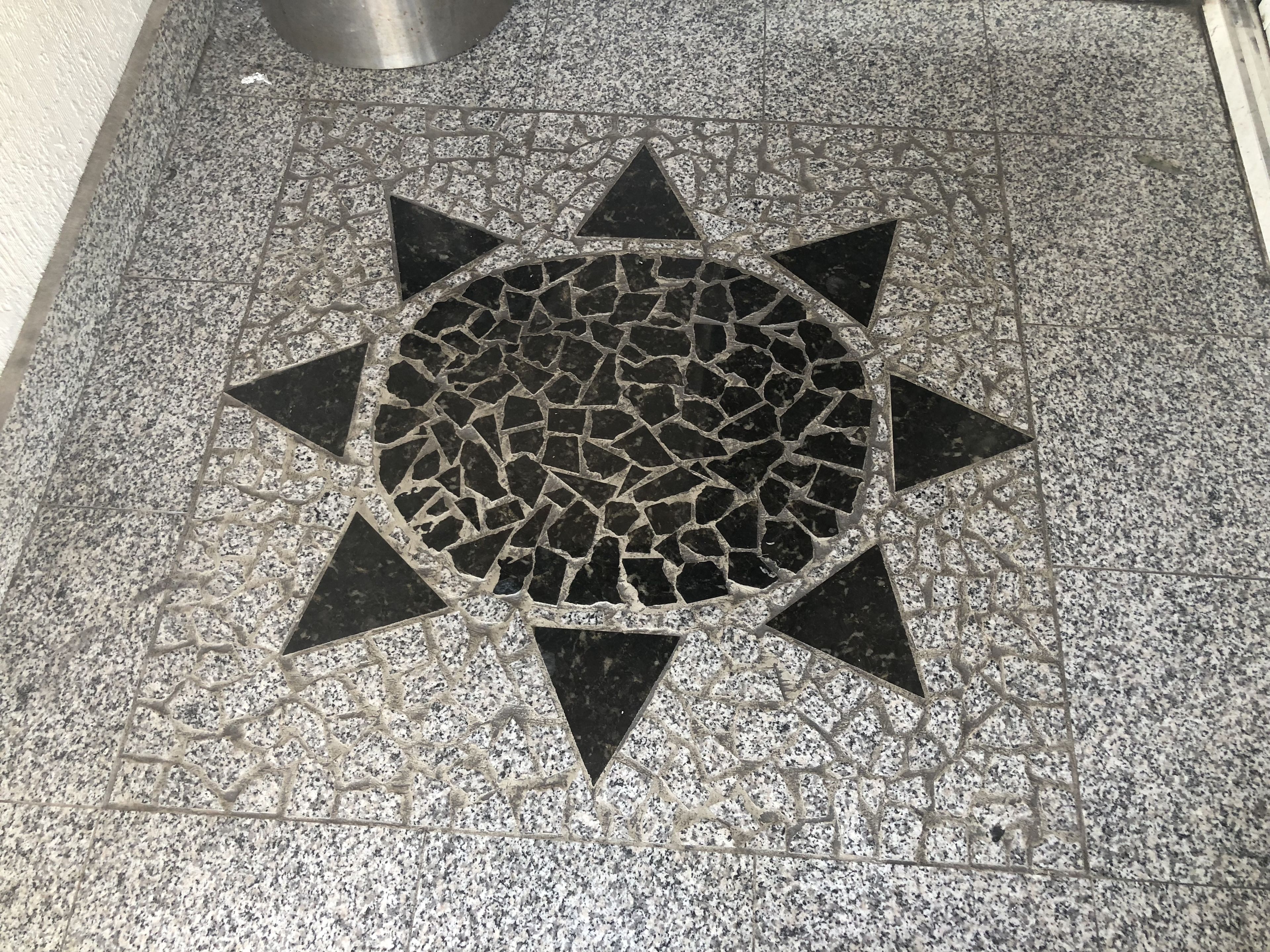 A floor with a sun-like pattern, likely a decorative design.