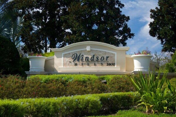 A sign for Windsor Hills 2600 with a landscaped garden in the foreground.