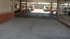 Een gebouwde ingang met een overdekte doorgang naar een parkeerplaats.