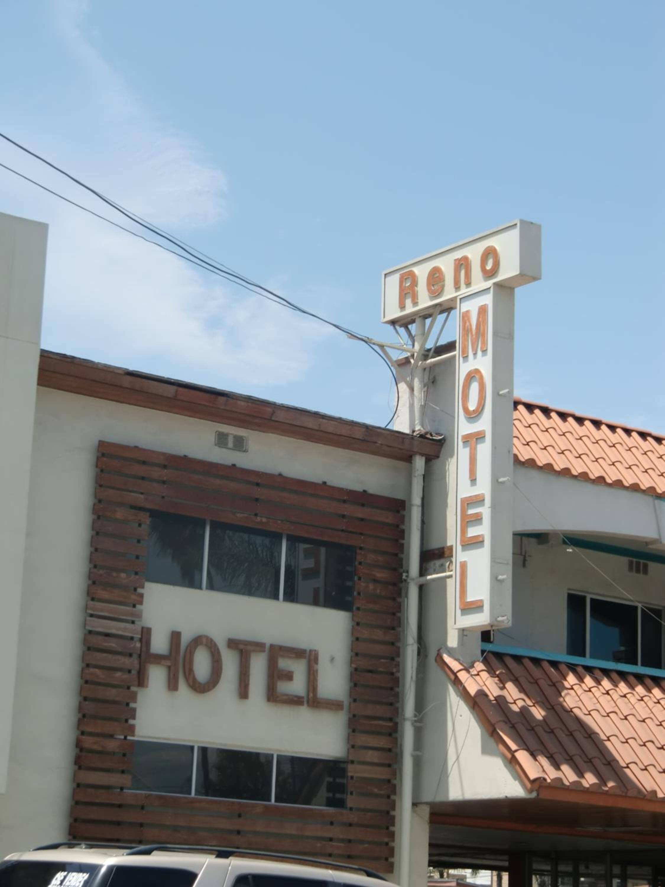 A hotel named Reno Motel with a prominent sign.