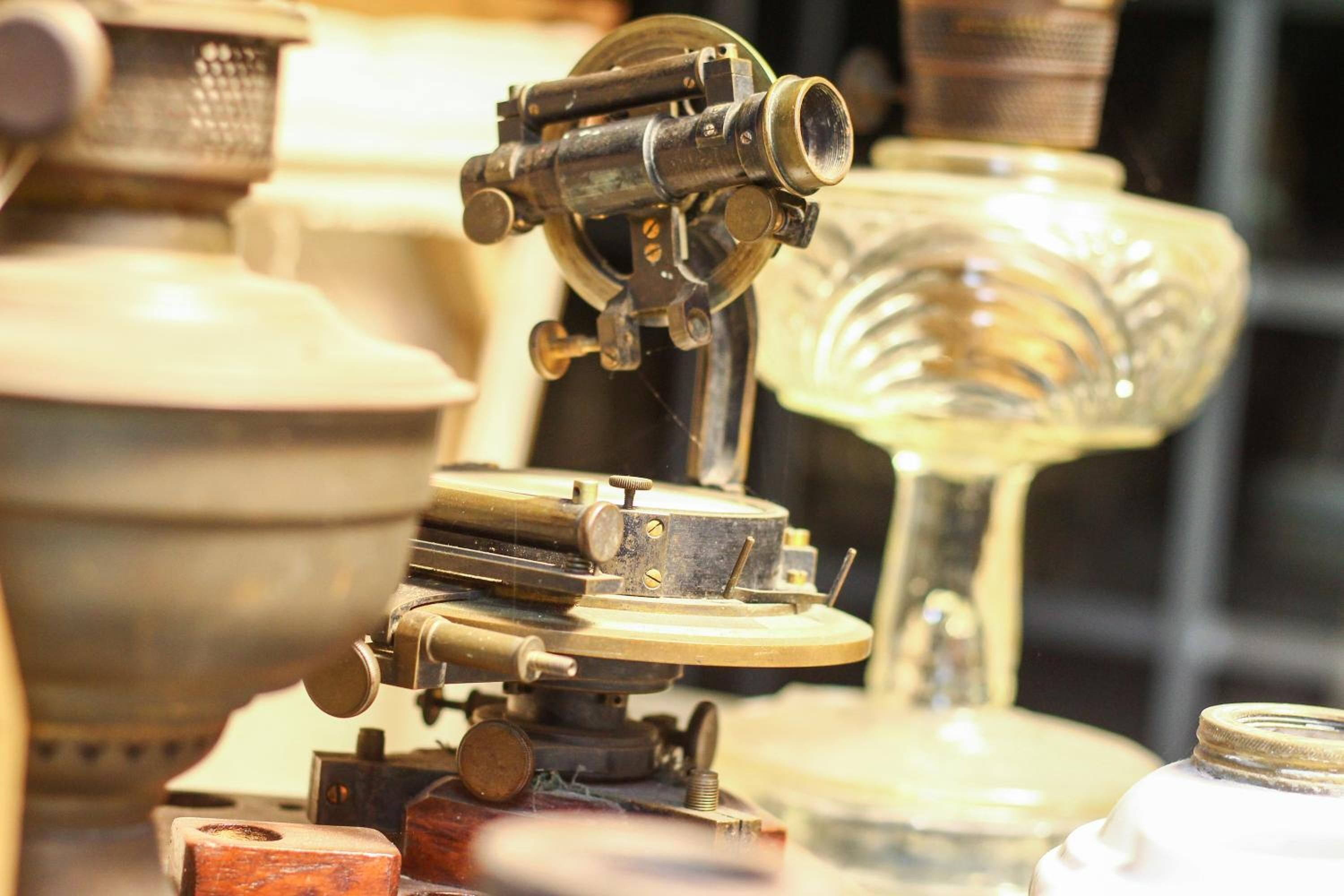 A close-up of a vintage telescope with intricate mechanical parts and a brass finish.