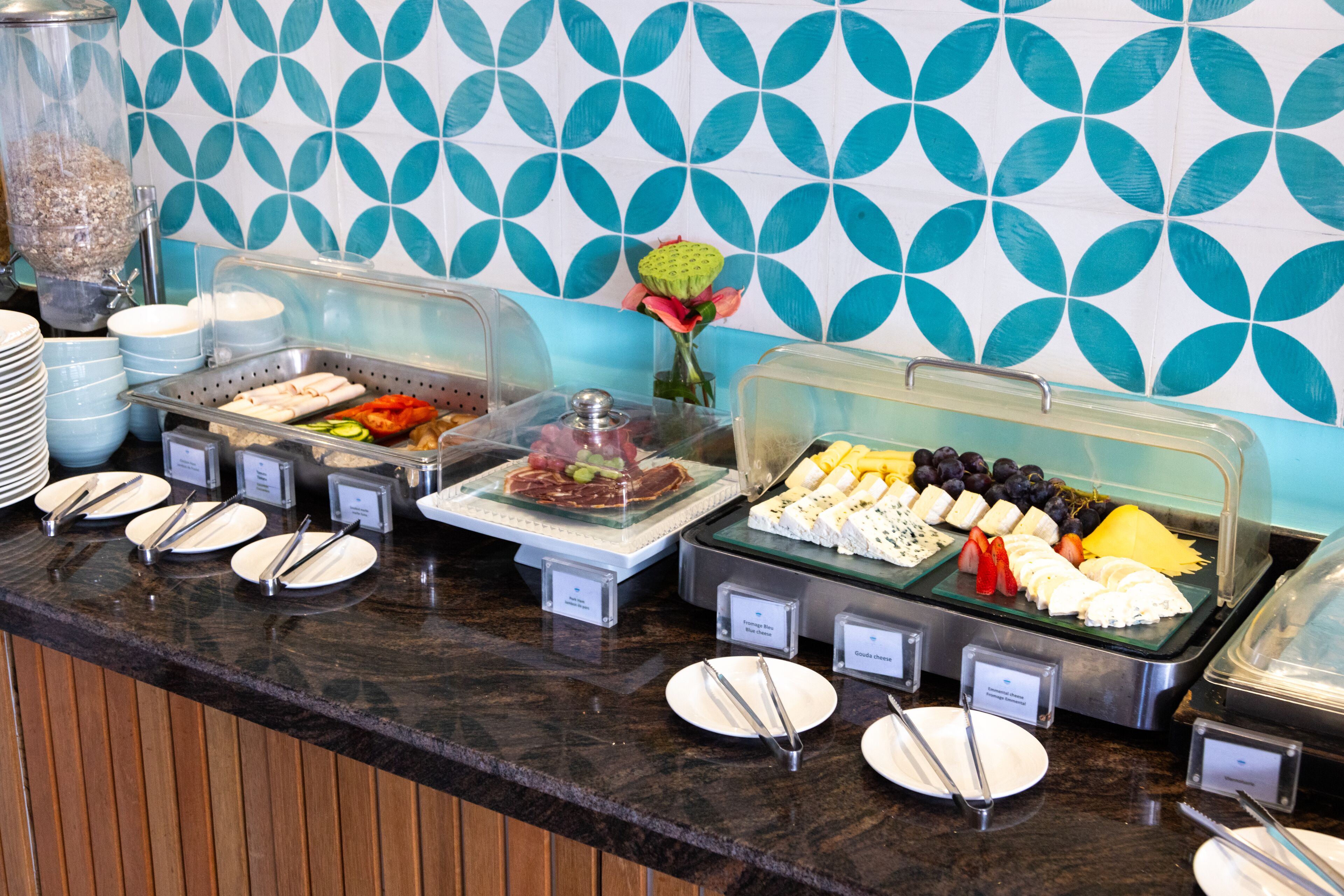A buffet with various food items and utensils.