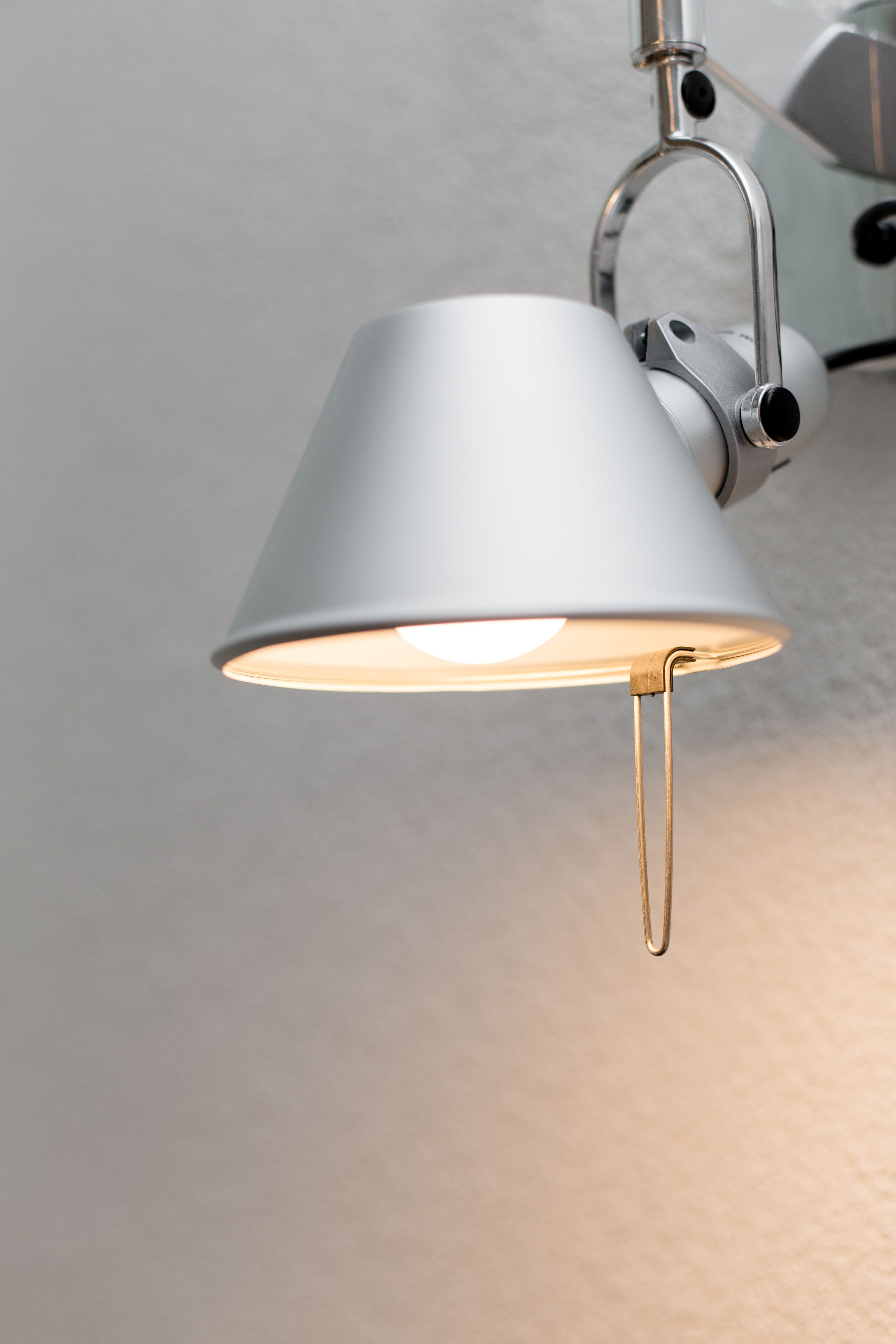 A ceiling-mounted lamp with a metallic finish and a white lampshade.