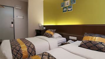A hotel room with two beds, a desk, a phone, and artwork on the wall.