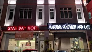 The exterior of Star Bay Hotel with a sign for Manjung Sandwich and Cafe below. - Star Bay Hotel (Lumut)