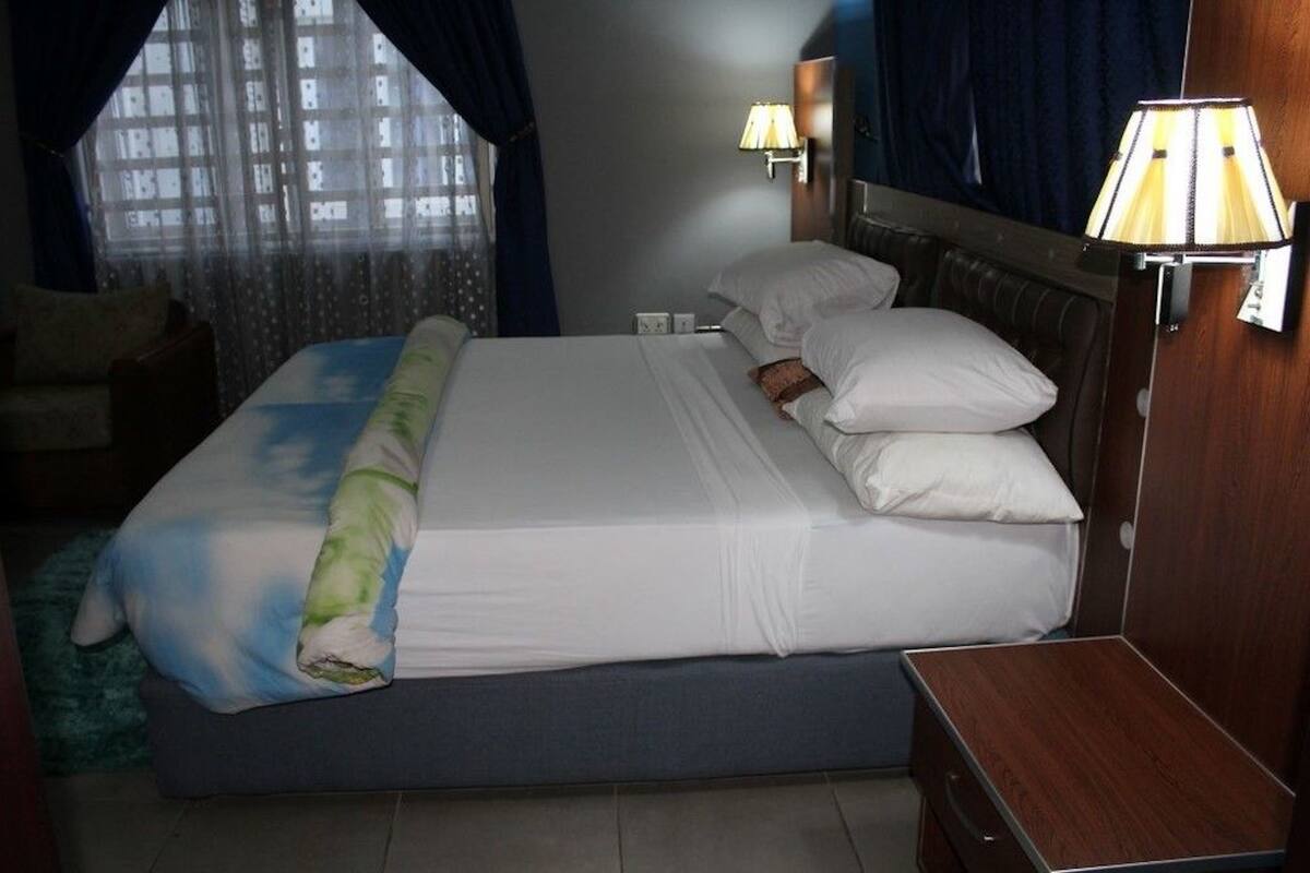 Premium bedding, desk, laptop workspace, blackout curtains