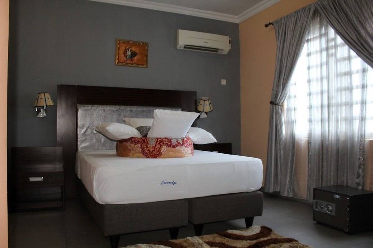 Deluxe Suite | Premium bedding, desk, laptop workspace, blackout curtains