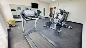 A gym with treadmills, an elliptical, and a mirrored wall. - Wingate by Wyndham Jonesboro/Hodge (Jonesboro)