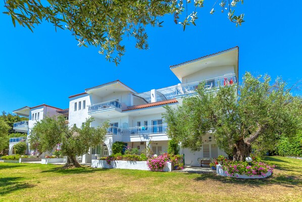 Stunning multi-story building with balconies and beautifully maintained grounds.