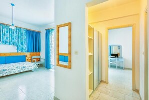 Relax in a serene space with a large window, wooden headboard, and comfortable bed.