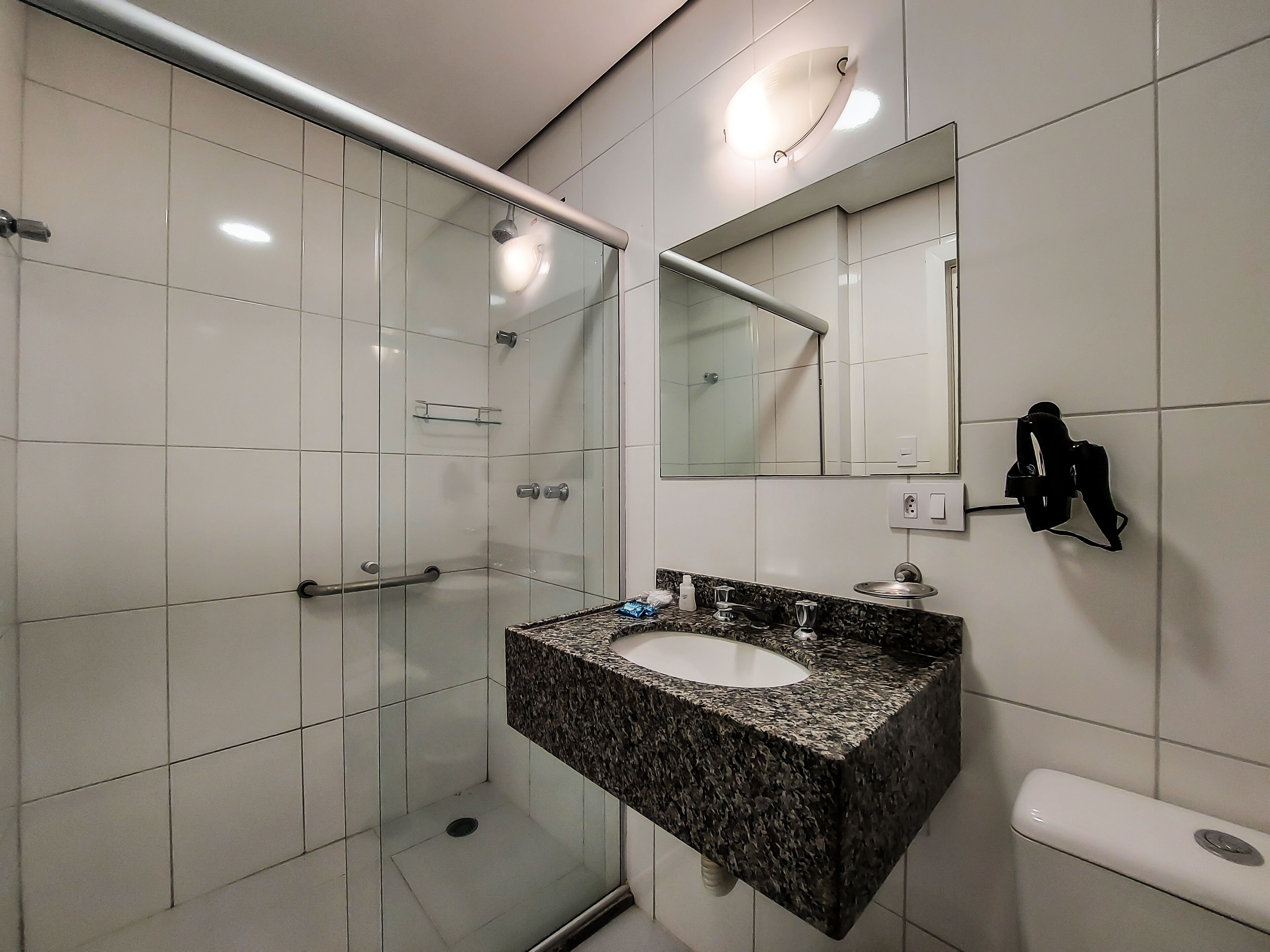 standard twin room | bathroom | shower, hair dryer, towels, soap