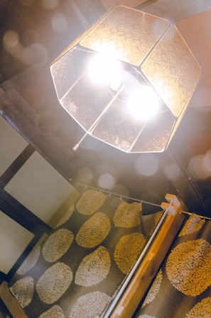 A ceiling with a geometric light fixture and patterned carpet. - HOSTEL NAKAMURA Kobe (Kobe)