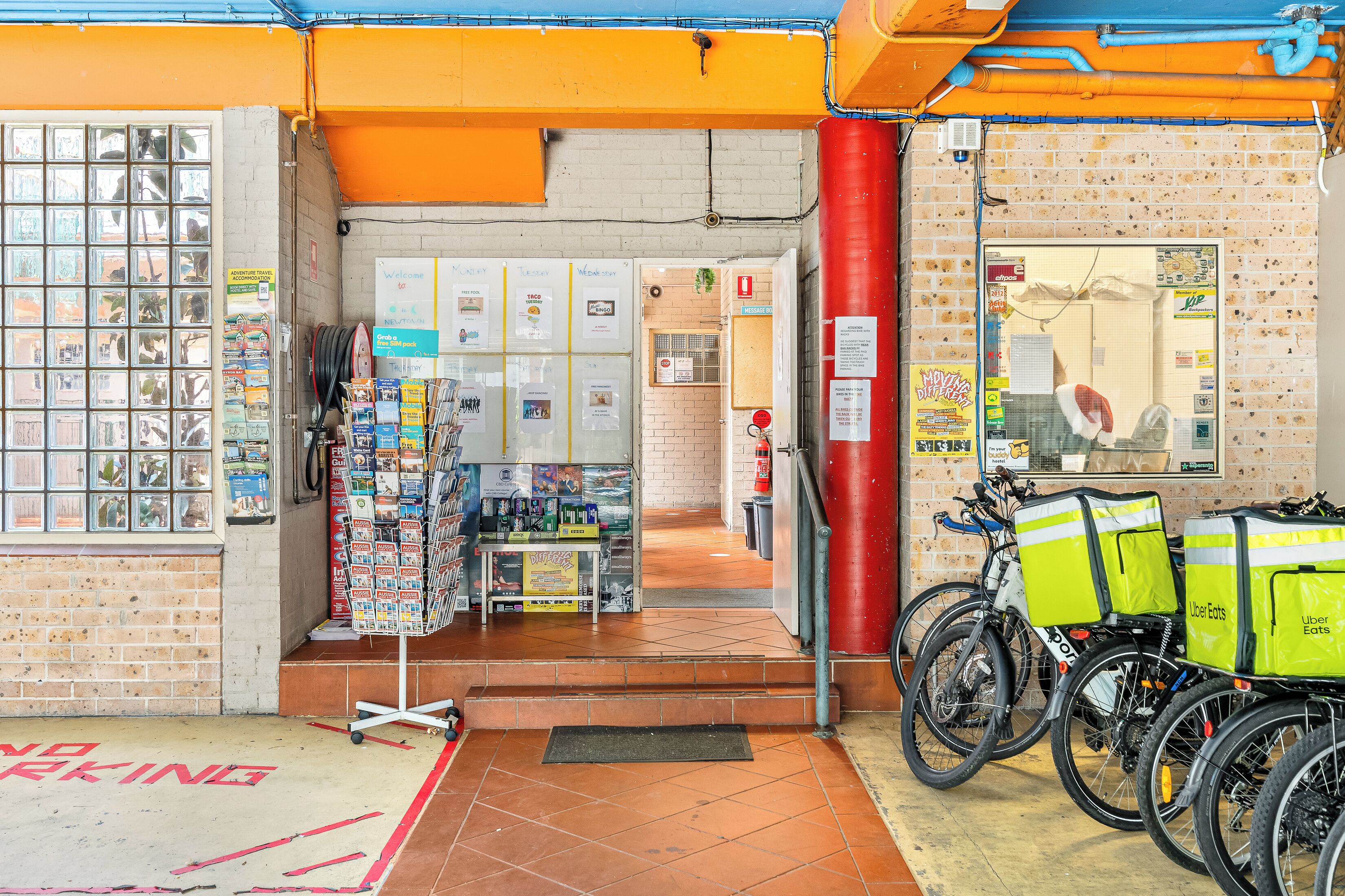 A storefront with a brick wall, a glass display case, and a bicycle delivery service.