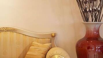A sofa with a curved backrest and a decorative pillow.