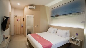 A hotel room with a bed, a desk, a phone, an air conditioner, and a painting of a pier. - Midtown Xpress Sampit Kalimantan Tengah (Sampit)