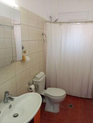 Apartment, 1 Bedroom, Sea View (Second Floor) | Bathroom | Combined shower/bathtub, rainfall showerhead, hair dryer, towels