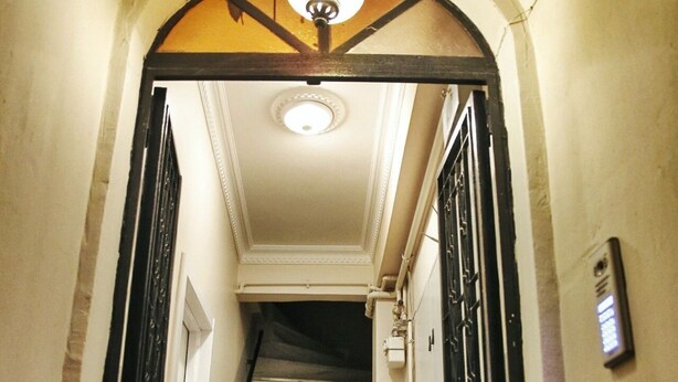 A hallway with a marble staircase, a patterned floor, and a ceiling light fixture. - Golden Galata Hotel (Istanbul)