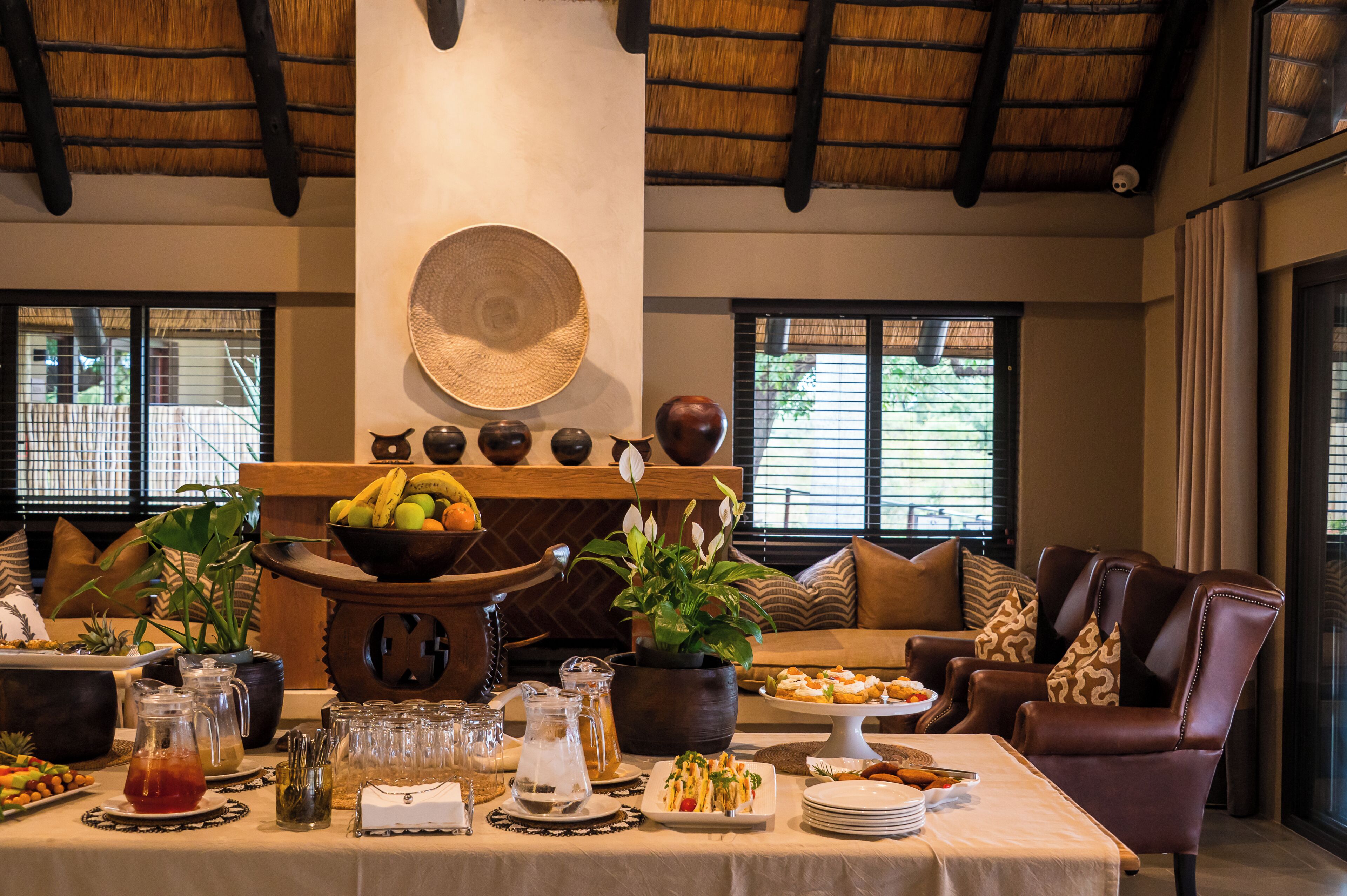 A dining area with a buffet setup, including a variety of food items and beverages.