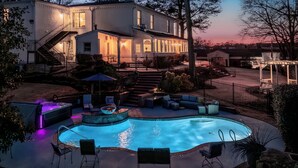 A residential property with a swimming pool, outdoor seating, and a staircase leading to the house. - Stone Mountain Manor (Stone Mountain)