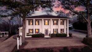 A large, two-story house with a symmetrical facade, central entrance, and evenly spaced windows. - Stone Mountain Manor (Stone Mountain)