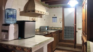 A kitchen with a refrigerator, water dispenser, and a sink. - Hotel Eden de los Angeles (San Miguel de Allende)