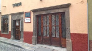 A building with a sign reading "HOTEL" above the entrance. - Hotel Eden de los Angeles (San Miguel de Allende)