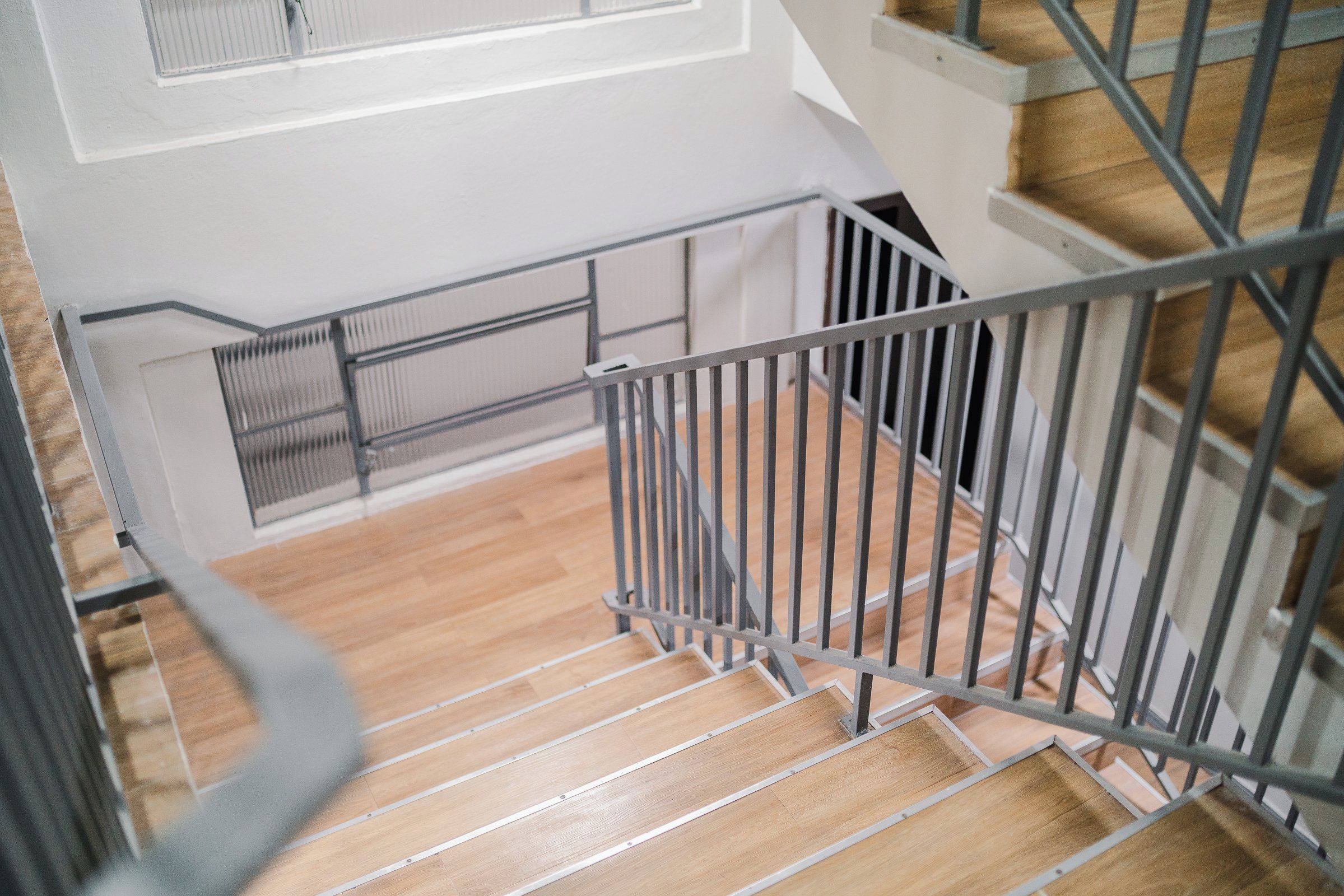 A staircase with metal railings and wooden steps.