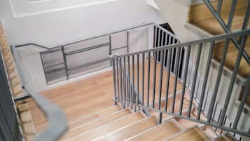 A staircase with metal railings and wooden steps.