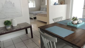 Family Suite, 2 Queen Beds, Accessible, Kitchenette | Living area | 20-inch flat-screen TV with cable channels, TV