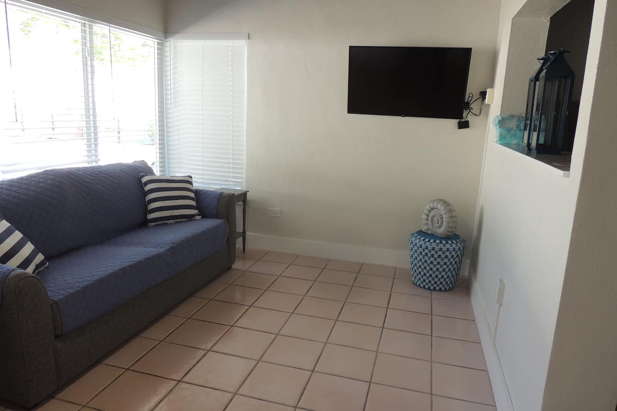 family suite, 2 queen beds, refrigerator & microwave | living area | 20-inch flat-screen tv with cable channels, tv