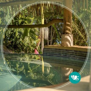 A circular view of a pool area surrounded by lush tropical vegetation. - Villas Del Caribe (Cahuita)
