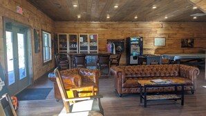 A wooden interior with a bar area, leather seating, and a vending machine.