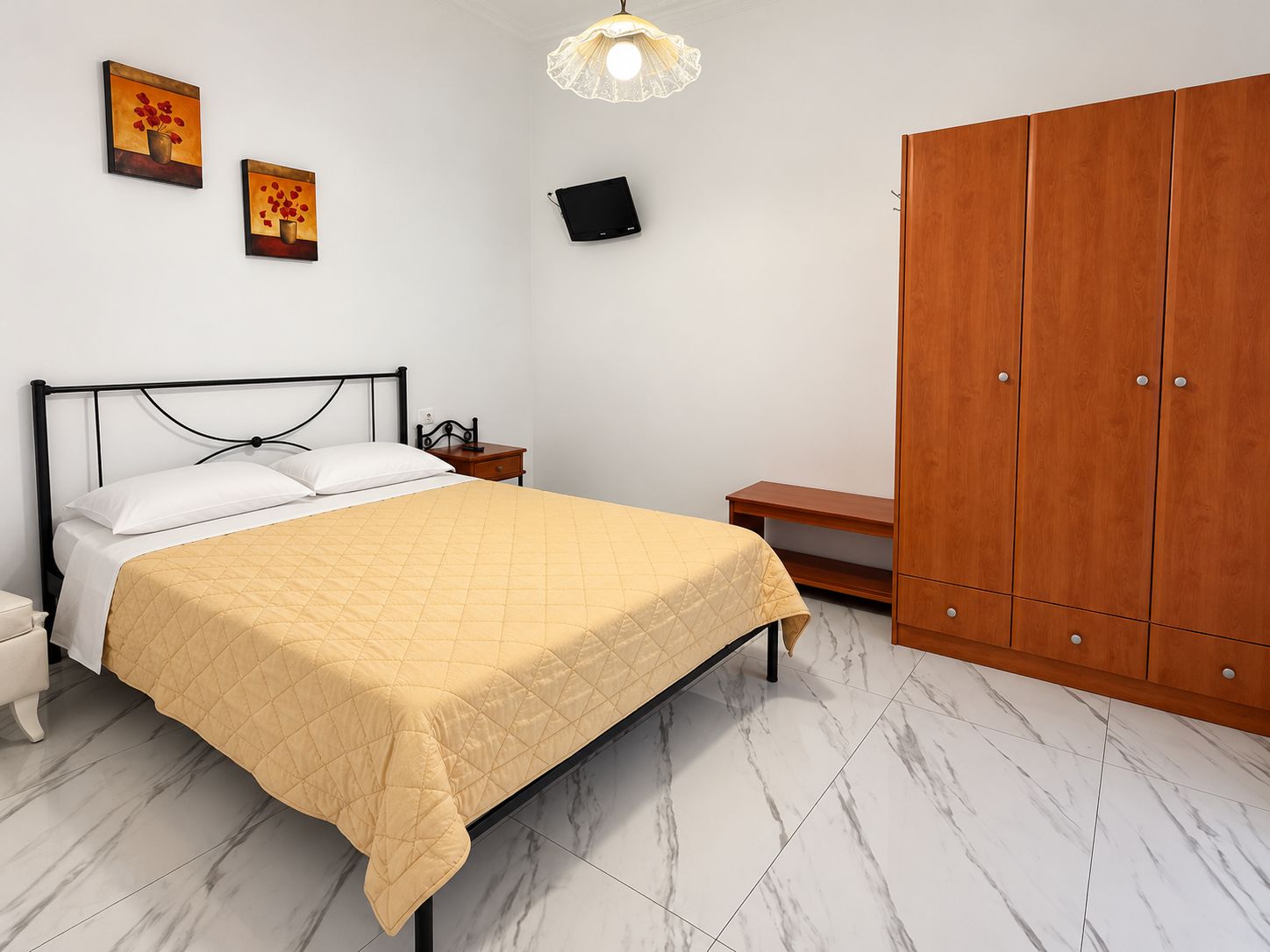 Un dormitorio con cama, mesita de noche, armario y una obra de arte en la pared.