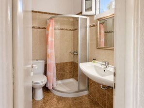 A bathroom with a shower, toilet, and sink. - Sofia Village (Mykonos)
