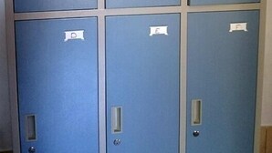 A row of six blue lockers with individual labels from A to F. - Same Same - Bungalows - Hostel (Kuta)