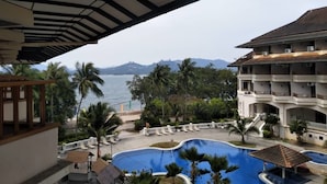 Ein Resort mit Pool, Palmen und Meerblick.