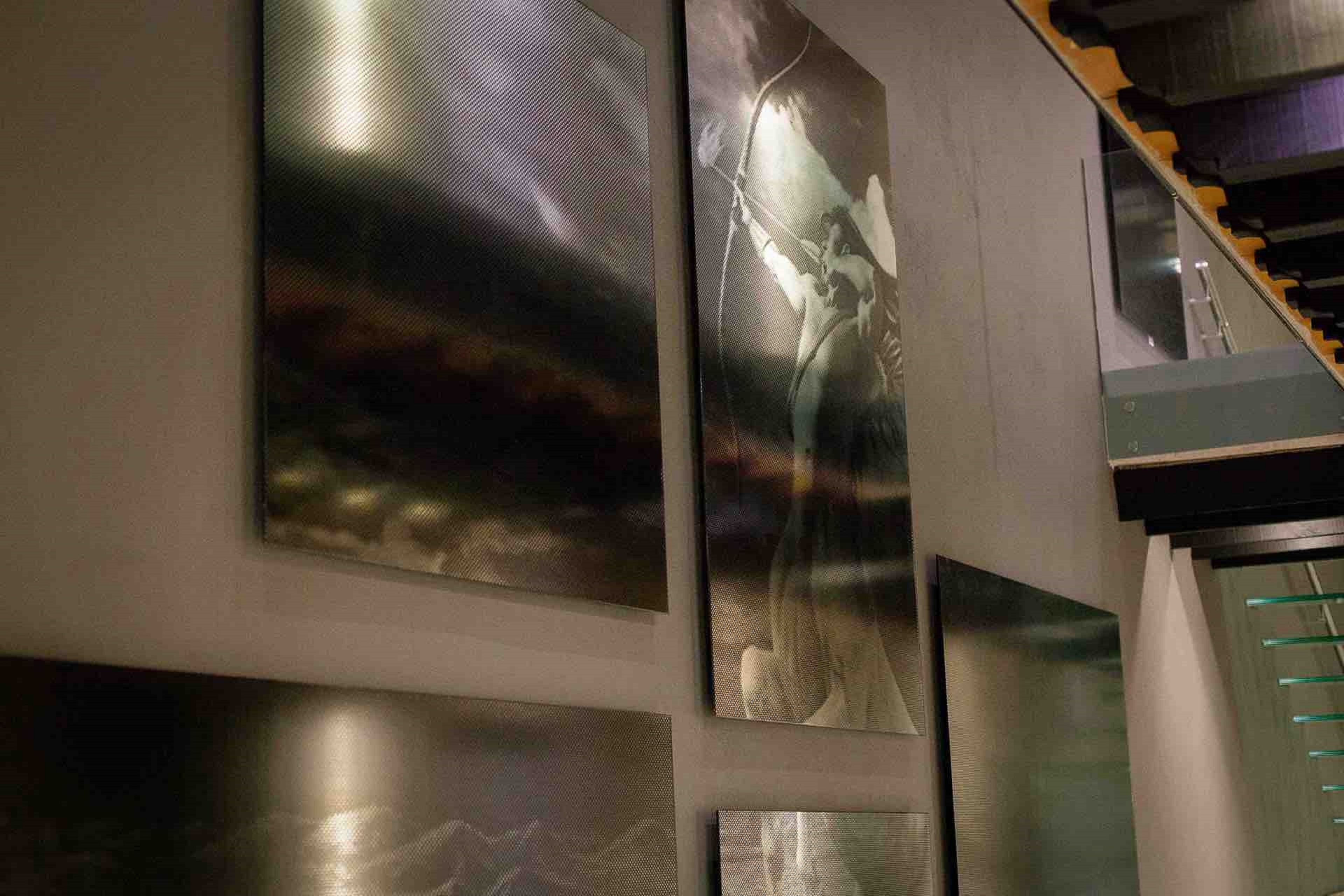 A modern interior with a staircase and abstract wall art.