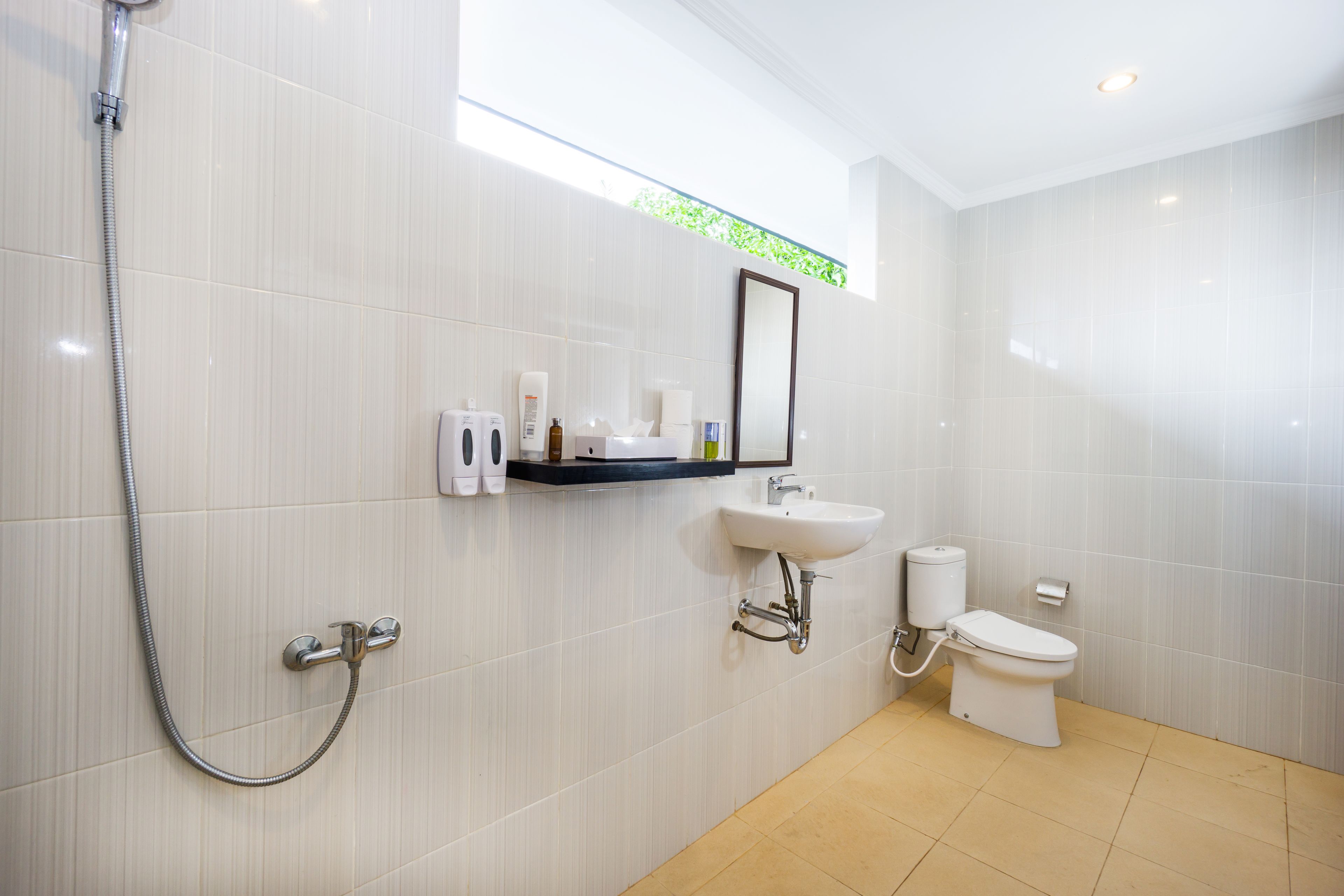 A modern bathroom with a shower, sink, and toilet.
