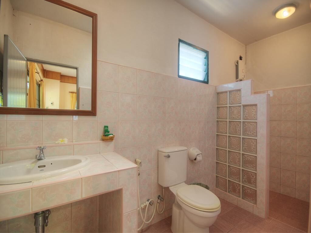 A bathroom with a sink, toilet, and shower.