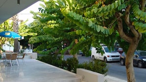 A covered outdoor seating area with a staircase leading to a higher level. - Dimitris Paritsa Hotel (Kos)