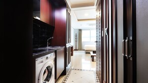A hotel room with a washing machine, a bed, and a bathroom with a large mirror. - Inter City Seoul (Seoul)
