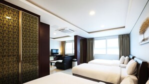 A hotel room with two beds, a desk, a chair, a television, and a large window with curtains. - Inter City Seoul (Seoul)