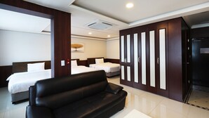 A modern hotel room with a large bed, a black leather sofa, and a wardrobe with mirrored doors. - Inter City Seoul (Seoul)