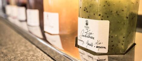 A row of glass jars with labels, likely containing beverages or food items.