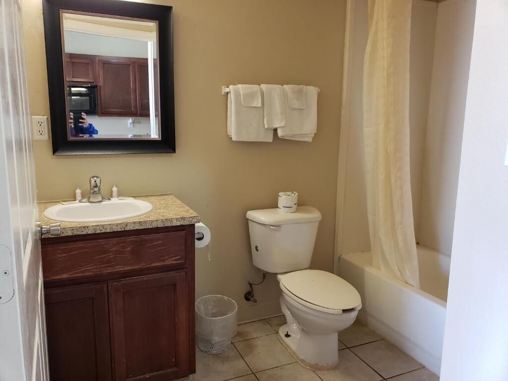 A bathroom with a sink, toilet, and bathtub.
