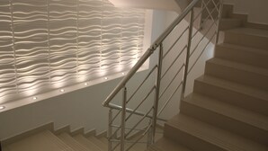 A modern staircase with a metal handrail and a textured wall with embedded lights. - Le Marde Hotel (Istanbul)